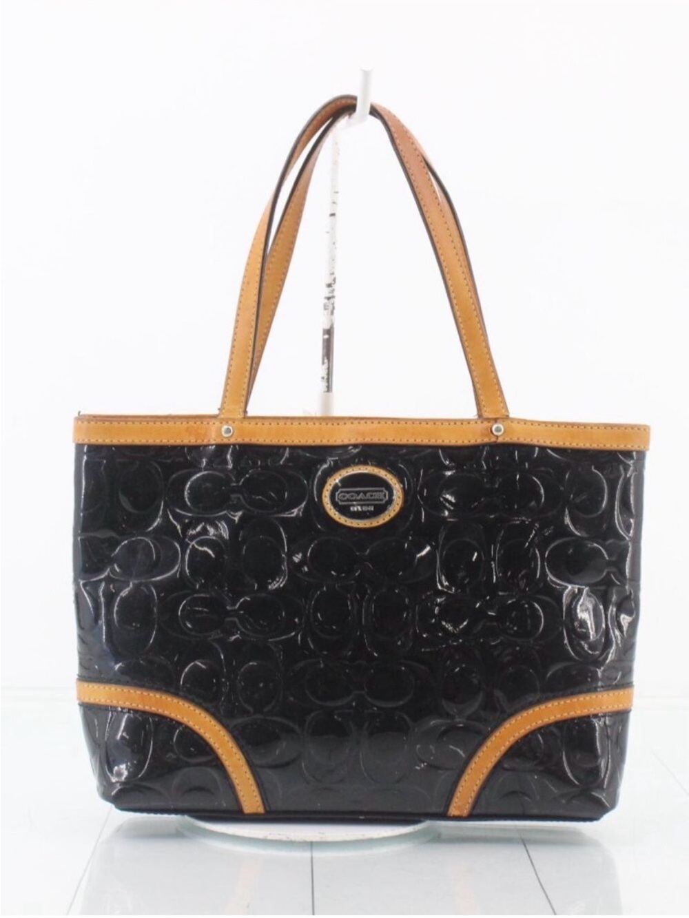COACH Peyton embossed patent leather tote with tan leather trim.